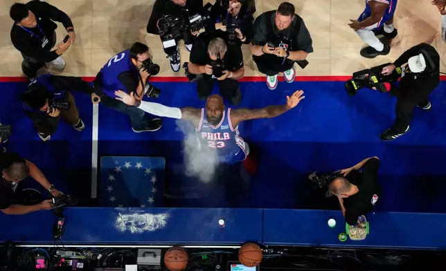 Philadelphia 76ers' LeBron James tosses chalk into the air before an NBA basketball game against the Cleveland Cavaliers Thursday, Oct. 22, 2026, in Philadelphia. (AP Photo/Matt Slocum)