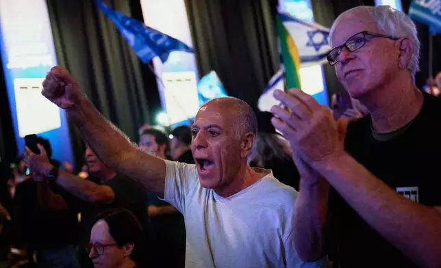 An audience member cheers as Gadi Eisenkot, leader of the Yashar ("Straight") party speaks at a campaign rally ahead of Israel's general election, Sunday, Oct. 25, 2026, in Tel Aviv, Israel. (AP Photo/David Goldman)
