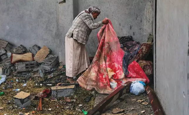 A man searches through the debris of his damaged home following airstrikes in Sanaa, Yemen, Saturday, Oct. 24, 2026. (AP Photo/Osamah Abdulrahman)