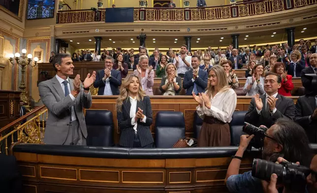 Spanish Prime Minister Pedro Sánchez, left, applauds at the Spanish parliament in Madrid, Friday Oct. 2, 2026. (Eduardo Parra/Europa Press via AP)