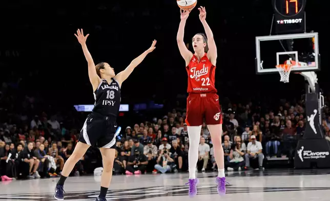 Indiana Fever guard Caitlin Clark (22) takes a three-point shot over Las Vegas Aces guard Mai Yamamoto (18) during the first half in Game 3 of an WNBA basketball first-round playoff series Thursday, Oct.1, 2026, in Las Vegas. (AP Photo/Steve Marcus)