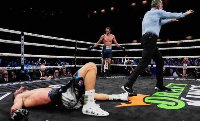 Sebastian Fundora, center rear, celebrates after knocking out Ermal Hadribeaj during a super welterweight championship boxing match Saturday, Oct. 17, 2026, in Las Vegas. (AP Photo/John Locher)
