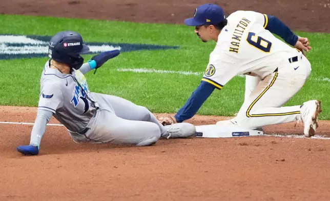 Tampa Bay Rays' Victor Mesa Jr. is tagged out stealing by Milwaukee Brewers third baseman David Hamilton during the fifth inning of Game 1 of baseball's World Series, Friday, Oct. 23, 2026, in Milwaukee, between the Milwaukee Brewers and the Tampa Bay Rays. (AP Photo/David J. Phillip)