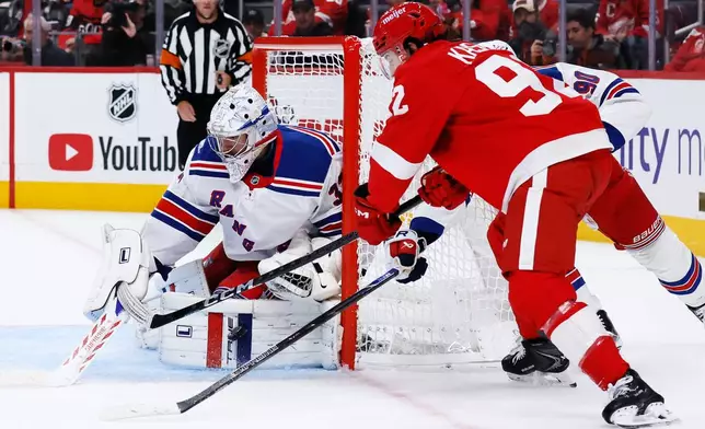 New York Rangers goaltender Dylan Garand, left, stops a shot by Detroit Red Wings center Marco Kasper (92) with Rangers center Joseph Veleno (90) helping defend the goal during the second period of an NHL hockey game Friday, Oct. 2, 2026, in Detroit. (AP Photo/Duane Burleson)