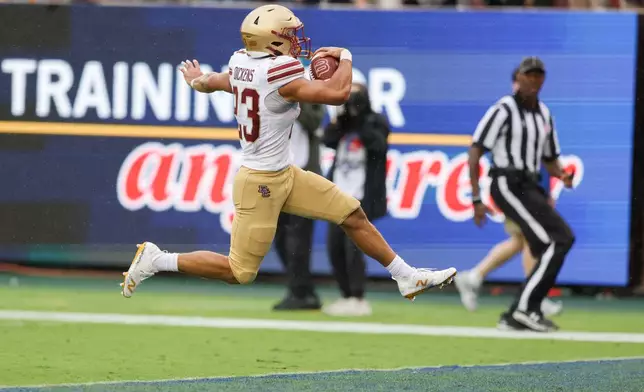 Boston College running back Evan Dickens leaps over the goal line for a touchdown during an NCAA college football game against SMU, Saturday, Oct. 3, 2026, in Dallas. (AP Photo/Gareth Patterson)
