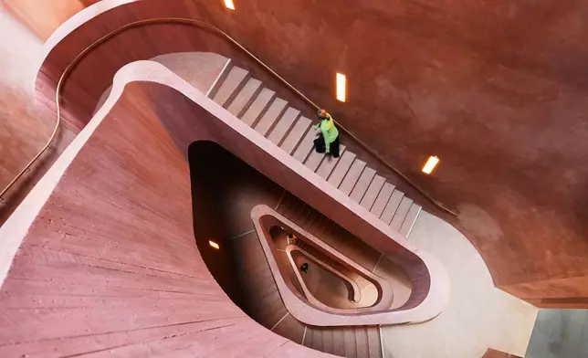 A visitors walks up the stairs at the Kueppersmuehle Museum in Duisburg, Germany, Wednesday, Oct. 28, 2026. (AP Photo/Martin Meissner)