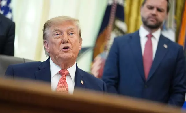 President Donald Trump speaks in the Oval Office of the White House, Tuesday, Oct. 20, 2026, in Washington, as Vice President JD Vance listens. (AP Photo/Jacquelyn Martin)