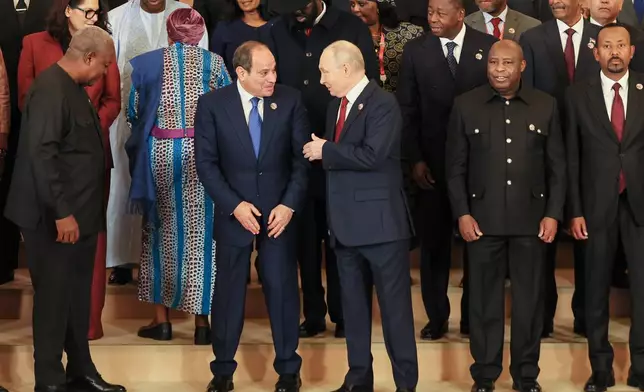 Russian President Vladimir Putin, centre, speaks with Egypt's President Abdel-Fattah el-Sissi while posing for a family photo at the Russia-Africa Summit in Moscow, Thursday, Oct. 29, 2026. (Anastasia Barashkova/Pool Photo via AP)