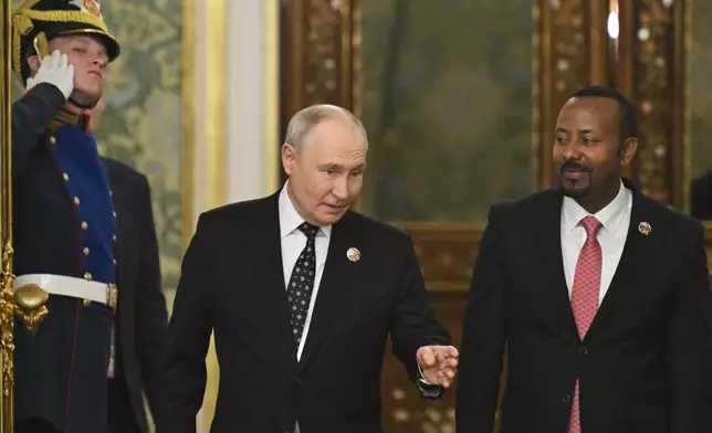Russian President Vladimir Putin, left, and Ethiopian Prime Minister Abiy Ahmed enter a hall for their meeting on the sidelines of the Russia-Africa Summit in Moscow, Wednesday, Oct. 28, 2026. (Igor Ivanko/Pool Photo via AP)