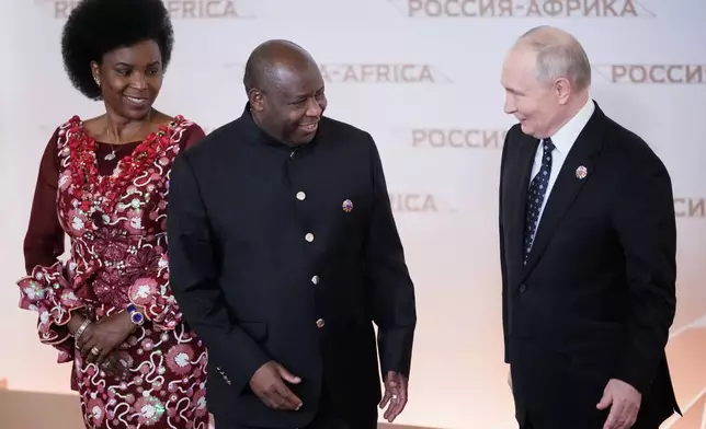 Russian President Vladimir Putin, right, greets Burundi's President Evariste Ndayishimiye and his wife Angeline at the Russia-Africa Summit in Moscow, Wednesday, Oct. 28, 2026. (AP Photo/Pavel Bednyakov)