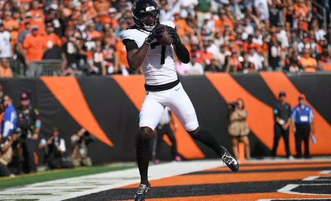 Jacksonville Jaguars wide receiver Brian Thomas Jr. (7) makes a touchdown catch during an NFL football game against the Cincinnati Bengals in Cincinnati, Sunday, Oct. 4, 2026. (AP Photo/Tanner Pearson)