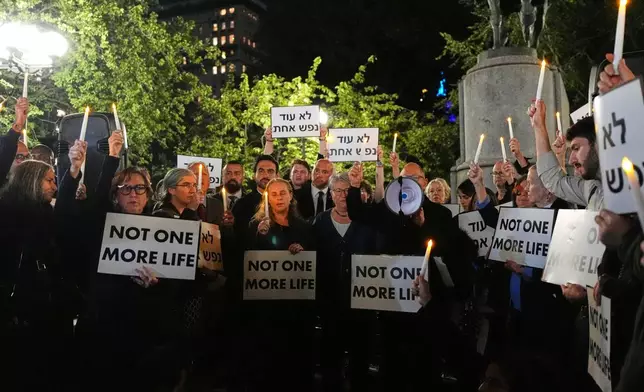 People attend a vigil marking the third anniversary of the October 7 attacks on Israel Wednesday, Oct. 7, 2026, in New York. (AP Photo/Frank Franklin II)