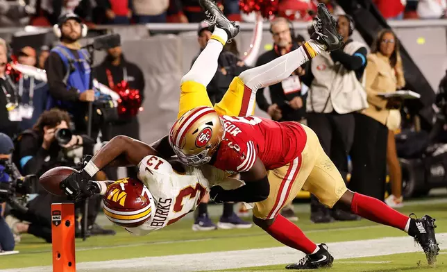 Washington Commanders wide receiver Treylon Burks (13) cannot catch a pass while being defended by San Francisco 49ers safety Malik Mustapha (6) during the second half of an NFL football game in Santa Clara, Calif., Monday, Oct. 19, 2026. (AP Photo/Kelley L. Cox)