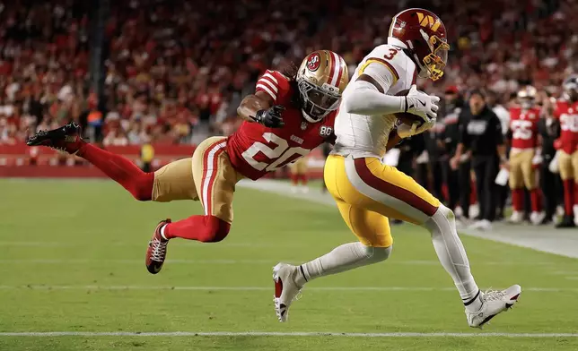 Washington Commanders wide receiver Stefon Diggs (3) scores past San Francisco 49ers cornerback Upton Stout (20) during the second half of an NFL football game in Santa Clara, Calif., Monday, Oct. 19, 2026. (AP Photo/Kelley L. Cox)