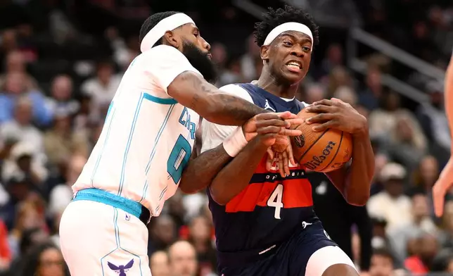 Washington Wizards forward AJ Dybantsa (4) goes to the basket against Charlotte Hornets forward Royce O'Neale, left, during the first half of an NBA Cup basketball game, Friday, Oct. 30, 2026, in Washington. (AP Photo/Nick Wass)