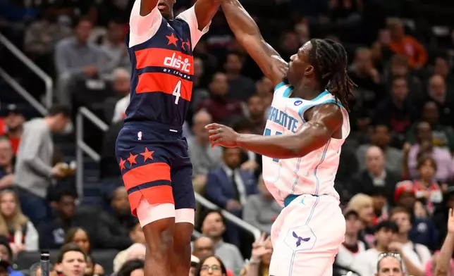 Washington Wizards forward AJ Dybantsa (4) shoots against Charlotte Hornets guard Sion James, right, during the first half of an NBA Cup basketball game, Friday, Oct. 30, 2026, in Washington. (AP Photo/Nick Wass)