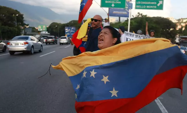 Supporters of Venezuelan opposition leader and Nobel Peace Prize laureate Maria Corina Machado celebrate following her return to the country after months abroad in Caracas, Venezuela, Sunday, Oct. 25, 2026. (AP Photo/Pedro Campos)