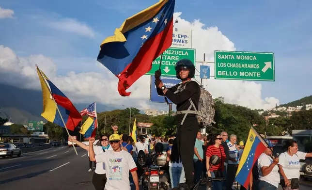 Supporters of Venezuelan opposition leader and Nobel Peace Prize laureate Maria Corina Machado celebrate her return to Venezuela after months abroad in Caracas, Venezuela, Sunday, Oct. 25, 2026 (AP Photo/Javier Campos)