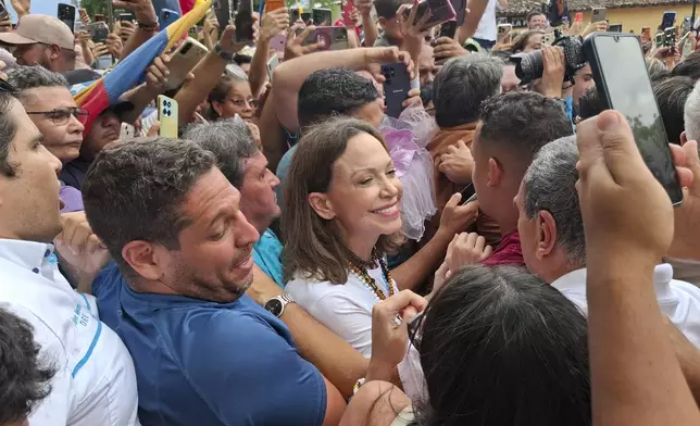 Venezuelan opposition leader Maria Corina Machado, center, greets supporters in Barquisimeto, Venezuela, Sunday, Oct. 25, 2026. (AP Photo/Jesus Hernandez)