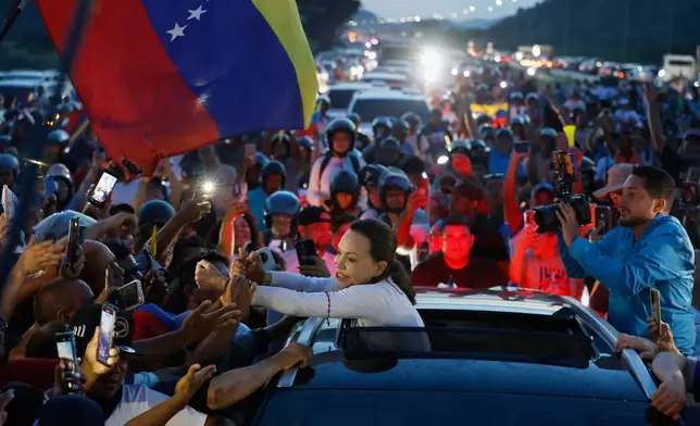 Venezuelan opposition leader and Nobel Peace Prize laureate Maria Corina Machado greets supporters in Valencia, Venezuela, following her return to the country after months abroad, Sunday, Oct. 25, 2026. (AP Photo/Pedro Mattey)