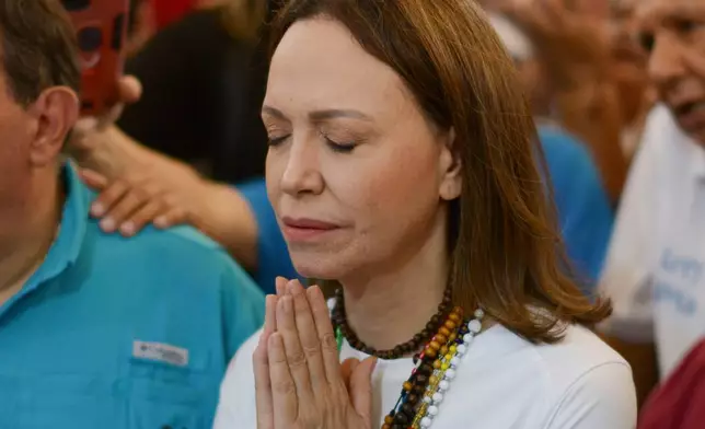 Venezuelan opposition leader Maria Corina Machado attends a religious Mass outside a church in Barquisimeto, Venezuela, Sunday, Oct. 25, 2026. (AP Photo/Jesus Hernandez)