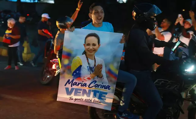 Supporters of Venezuelan opposition leader and Nobel Peace Prize laureate Maria Corina Machado celebrate her return to the country after months abroad in Caracas, Venezuela, Sunday, Oct. 25, 2026 (AP Photo/Javier Campos)