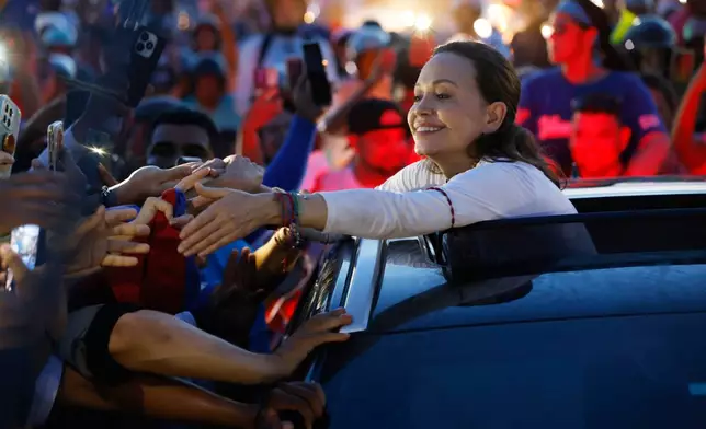 Venezuelan opposition leader and Nobel Peace Prize laureate Maria Corina Machado greets supporters in Valencia, Venezuela, following her return to the country after months abroad, Sunday, Oct. 25, 2026. (AP Photo/Pedro Mattey)