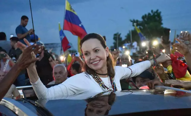 Venezuelan opposition leader and Nobel Peace Prize laureate Maria Corina Machado greets supporters in Valencia, Venezuela, following her return to the country after months abroad, Sunday, Oct. 25, 2026. (AP Photo/Jacinto Oliveros)