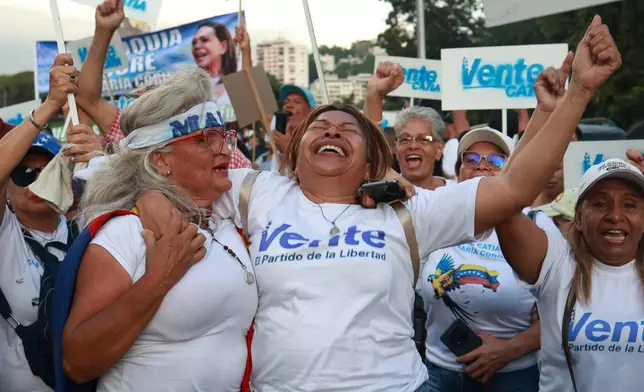 Supporters of Venezuelan opposition leader and Nobel Peace Prize laureate Maria Corina Machado celebrate her return to the country after months abroad in Caracas, Venezuela, Sunday, Oct. 25, 2026 (AP Photo/Javier Campos)
