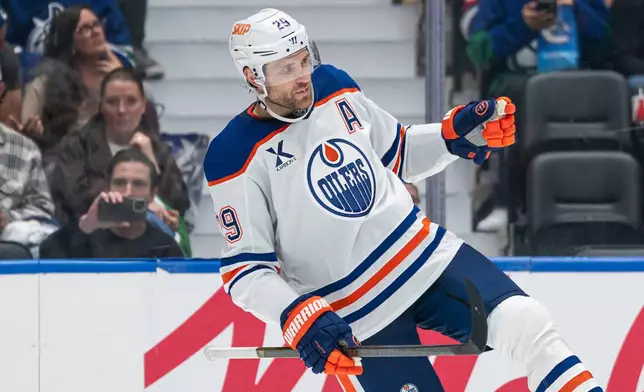 Edmonton Oilers' Leon Draisaitl (29) celebrates after scoring goal against the Vancouver Canucks during second period NHL hockey action in Vancouver, B.C., on Thursday, Oct. 1, 2026. (Rich Lam/The Canadian Press via AP)