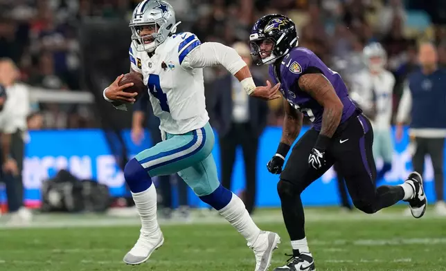 Dallas Cowboys quarterback Dak Prescott (4) runs against Baltimore Ravens safety Kyle Hamilton (14) during the second half of an NFL football game in Rio de Janeiro, Sunday, Sept. 27, 2026. (AP Photo/Fernando Llano)