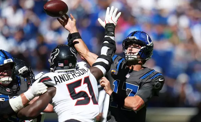 Indianapolis Colts quarterback Daniel Jones (17) throws an incomplete pass as he is pressured by Houston Texans defensive end Will Anderson Jr. (51) during the first half of an NFL football game, Sunday, Sept. 27, 2026, in Indianapolis. (AP Photo/Jeff Roberson)
