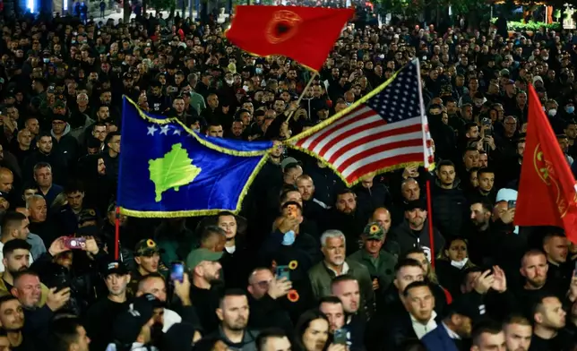 People take part in a protest near the parliament building ahead of the extraordinary parliament session to elect the new president in capital Pristina, Kosovo, Tuesday, Oct. 6, 2026. (AP Photo/Visar Kryeziu)
