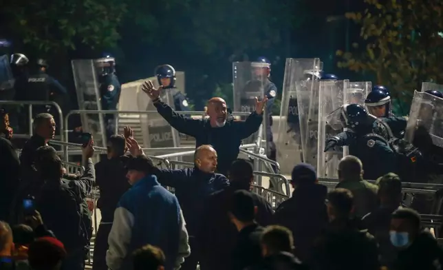 People take part in a protest near the parliament building ahead of the extraordinary parliament session to elect the new president in capital Pristina, Kosovo, Tuesday, Oct. 6, 2026. (AP Photo/Visar Kryeziu)