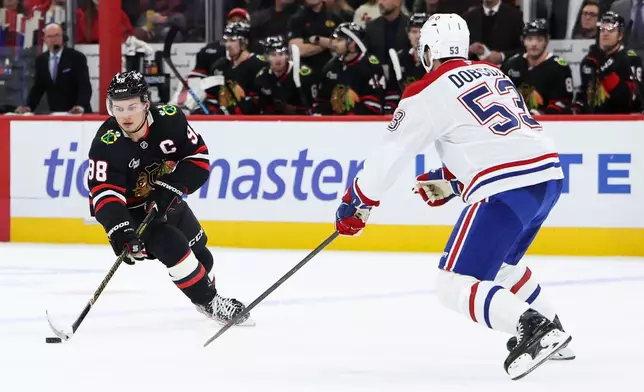Chicago Blackhawks center Connor Bedard (98) skates with the puck against Montreal Canadiens defenseman Noah Dobson (53) during the second period of an NHL hockey game, Friday, Oct. 23, 2026, in Chicago. (AP Photo/Jessie Alcheh)