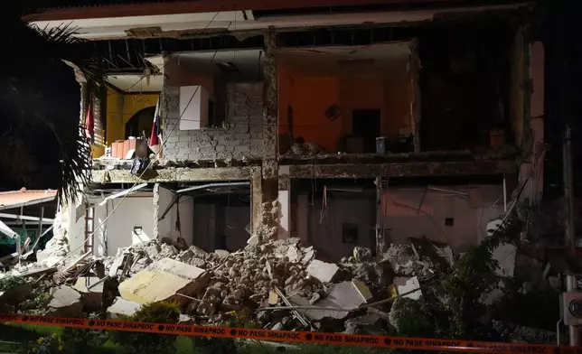 A partially collapsed building stands after an earthquake struck Penonome, Panama, Friday, Oct. 9, 2026. (AP Photo/Aris Mariota)