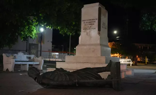 A statue lies on the ground after being knocked off its pedestal by an earthquake in Penonome, Panama, Friday, Oct. 9, 2026. (AP Photo/Aris Mariota)