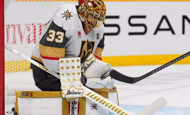 Vegas Golden Knights goaltender Adin Hill (33) blocks a shot on goal during the second period of an NHL hockey game against the Nashville Predators, Tuesday, Oct. 13, 2026, in Nashville, Tenn. (AP Photo/George Walker IV)