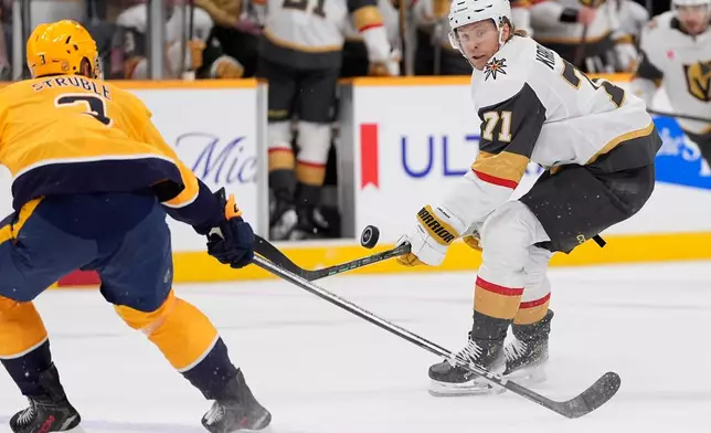 Vegas Golden Knights center William Karlsson (71) hits a loose puck past Nashville Predators defenseman Jayden Struble (3) during the first period of an NHL hockey game Tuesday, Oct. 13, 2026, in Nashville, Tenn. (AP Photo/George Walker IV)