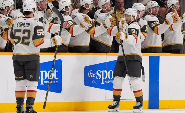 Vegas Golden Knights center William Karlsson (71) celebrates his goal with teammates during the second period of an NHL hockey game against the Nashville Predators, Tuesday, Oct. 13, 2026, in Nashville, Tenn. (AP Photo/George Walker IV)