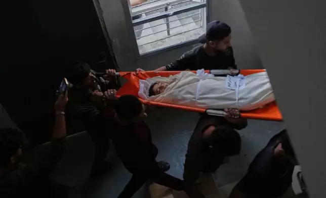 Mourners carry the body of Palestinian boy Hussam Hosso, who was killed by an Israeli airstrike late Thursday, during his funeral in Gaza City, Friday, Oct. 9, 2026. (AP Photo/Jehad Alshrafi)
