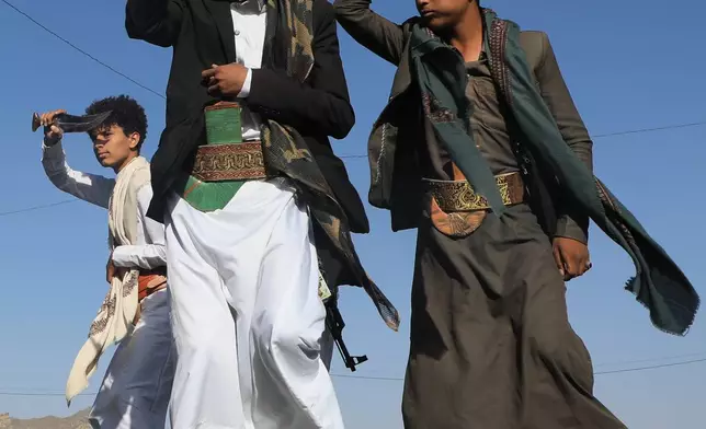 Men dance during a wedding celebration in a street in Sanaa, Yemen, Thursday, Oct. 8, 2026. (AP Photo/Osamah Abdulrahman)