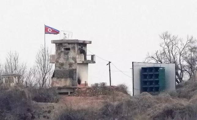 FILE - A soldier stands at a North Korean military guard post next to loudspeakers, seen from Paju, South Korea, near the border with North Korea, on Feb. 26, 2026. (AP Photo/Ahn Young-joon, File)