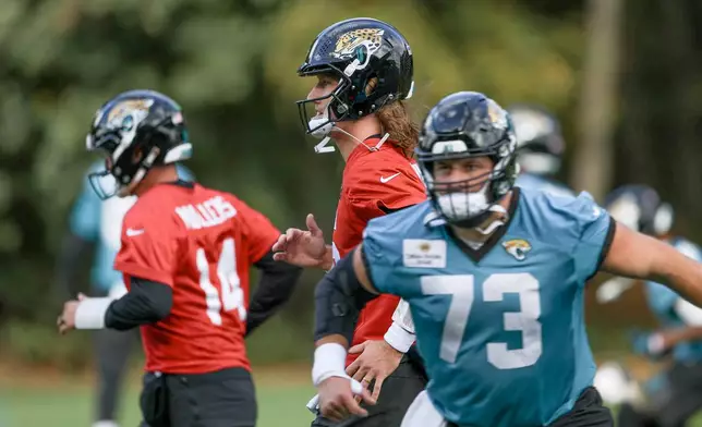 Jacksonville Jaguars quarterback Trevor Lawrence (16) during an NFL football practice in Hertfordshire, England, Friday, Oct. 16, 2026. (AP Photo/Adam Bettcher)