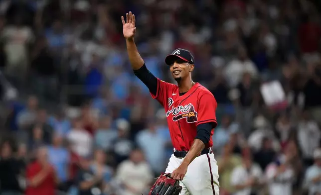 Atlanta Braves pitcher Ray Kerr waves as he walks to the dugout against the Philadelphia Phillies in the fourth inning during Game 3 of baseball's NL Wild Card Series, Thursday, Oct. 1, 2026, in Atlanta. (AP Photo/Brynn Anderson)