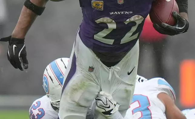 Baltimore Ravens running back Derrick Henry (22) is tackled by Tennessee Titans safety Kevin Winston Jr. (23) during the second half of an NFL football game in Baltimore, Sunday, Oct. 4, 2026. (AP Photo/Stephanie Scarbrough)