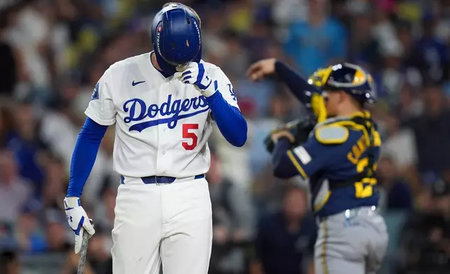 Los Angeles Dodgers first baseman Freddie Freeman walks to the dugout after striking out during the fifth inning of Game 4 of baseball's National League Championship Series between the Milwaukee Brewers and the Los Angeles Dodgers, Thursday, Oct. 15, 2026, in Los Angeles. (AP Photo/Gregory Bull)