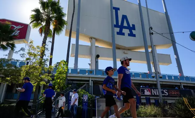 Fans arrive prior to Game 4 of baseball's National League Championship Series between the Milwaukee Brewers and the Los Angeles Dodgers, Thursday, Oct. 15, 2026, in Los Angeles. (AP Photo/Ashley Landis)