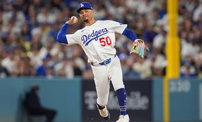Los Angeles Dodgers shortstop Mookie Betts thorns out Milwaukee Brewers catcher William Contreras on a ground out during the sixth inning of Game 3 of baseball's National League Championship Series between the Milwaukee Brewers and the Los Angeles Dodgers, Wednesday, Oct. 14, 2026, in Los Angeles. (AP Photo/Gregory Bull)