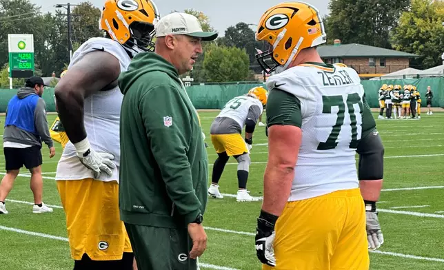 Green Bay Packers offensive coordinator Adam Stenavich speaks with linemen Kevin Zeitler (70) and Mekhi Becton during practice Wednesday, Sept. 30, 2026, in Green Bay, Wis. (AP Photo/Steve Megargee)